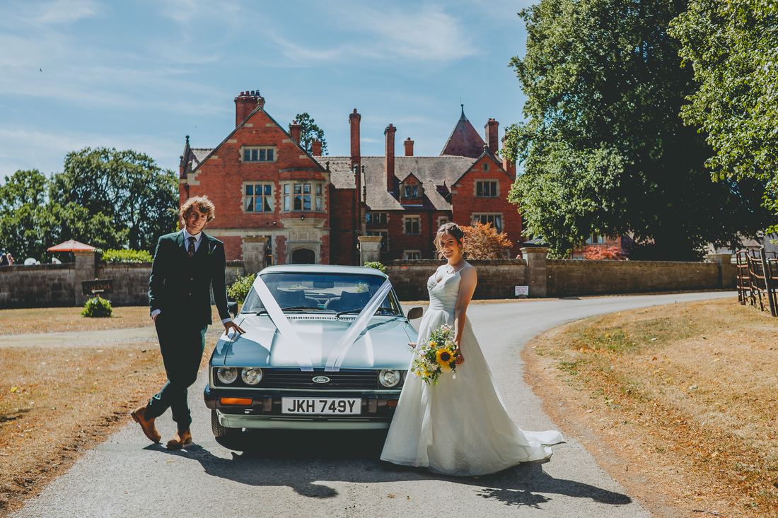 Newlywed portraits with the wedding car, Wigfair Hall wedding photography, North Wales